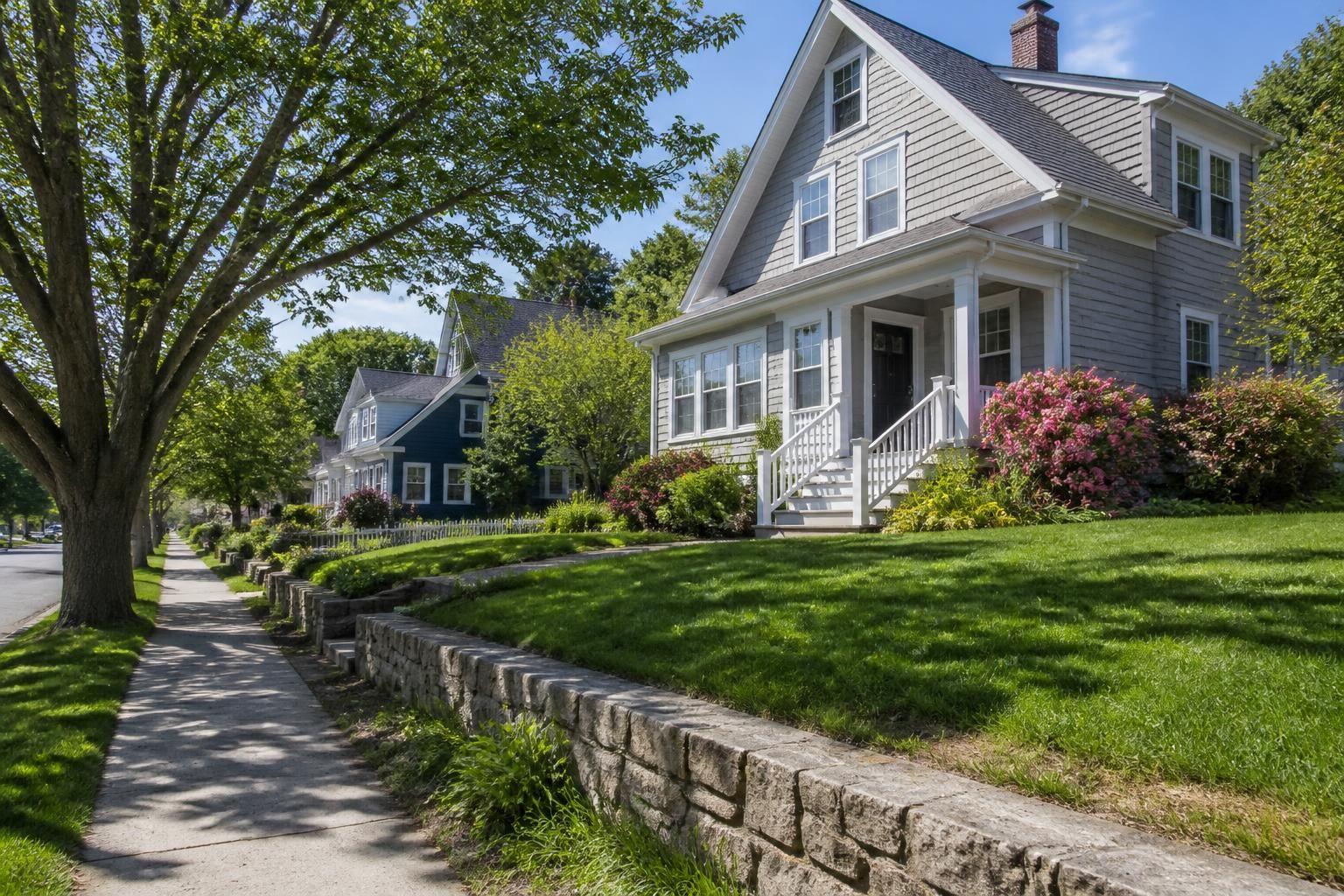 Neat suburban neighborhood with green lawns and calm streets.